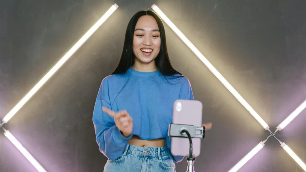 Content creator recording an engaging Instagram Reel on a smartphone with professional lighting, demonstrating the importance of capturing viewers' attention within the first three seconds.
